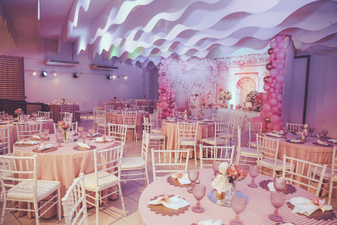 about-img Beautiful pink-themed event setup with balloons and decorated tables.